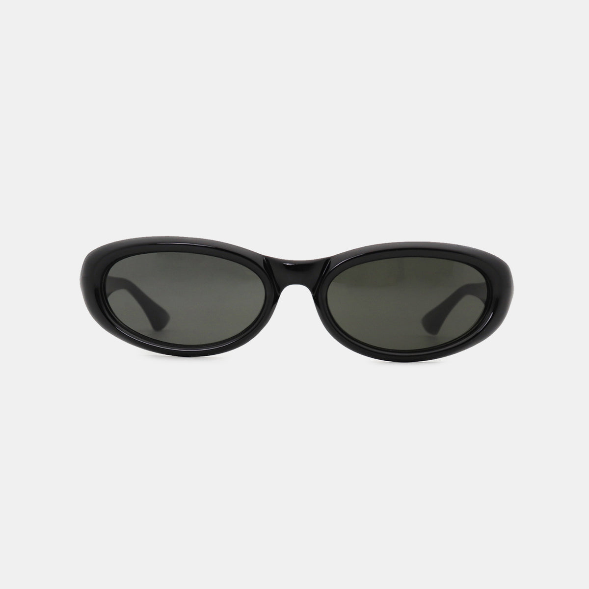 Black polycarbonate cat-eye sunglasses feature softly sculpted oval lenses, a smooth frame, gently raised outer edges, and tapered temples.
