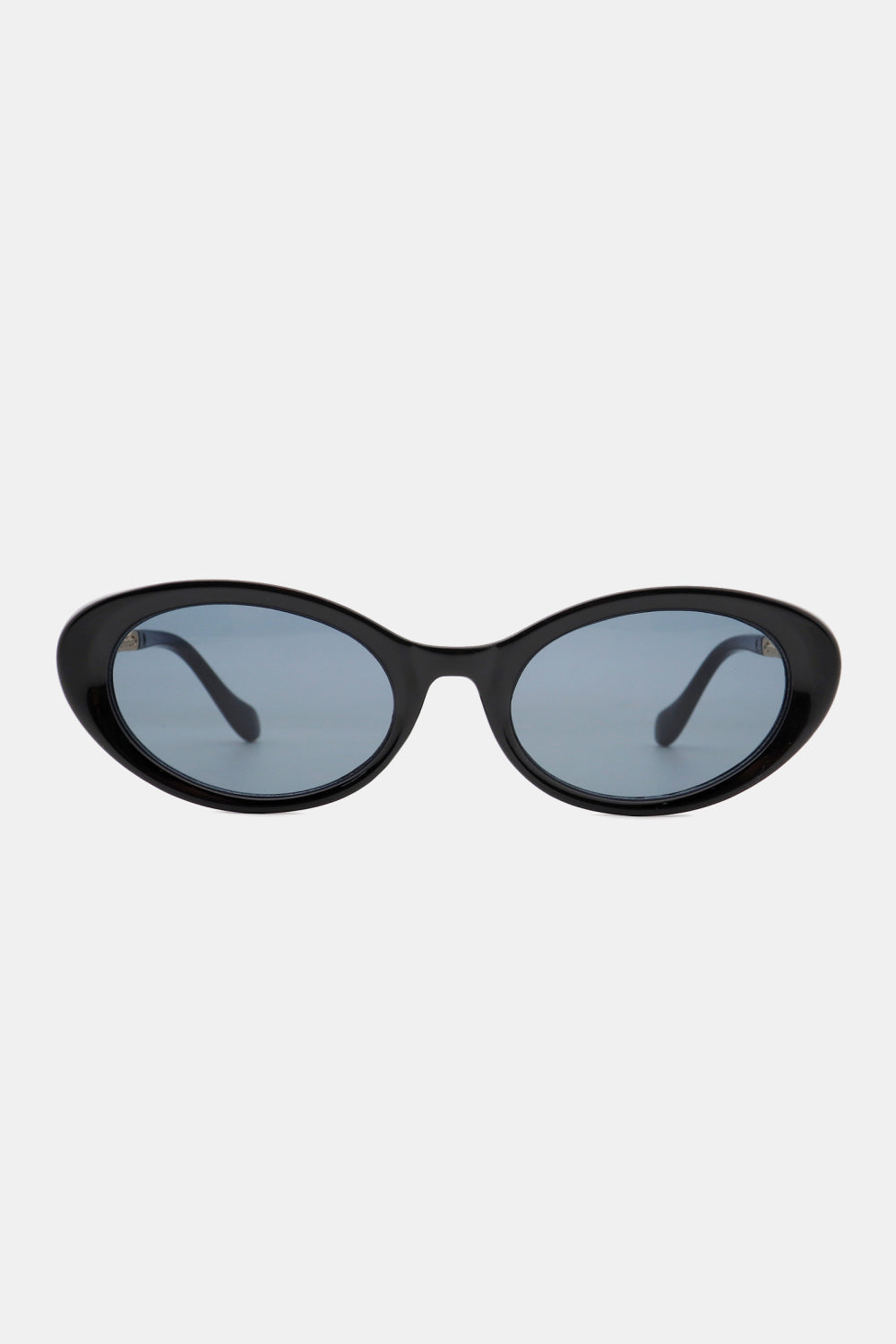 Black polycarbonate cat-eye sunglasses feature a softly upswept frame, rounded blue-tinted lenses, and streamlined temples.