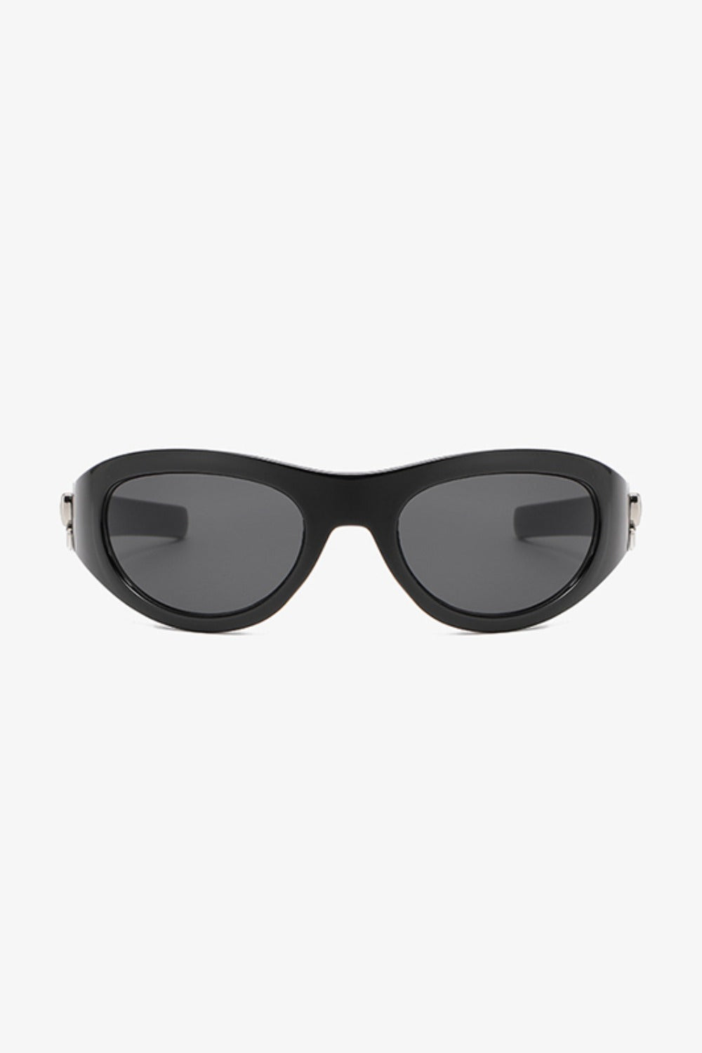 Black polycarbonate cat-eye sunglasses feature rounded dark lenses, softly upswept outer corners, a streamlined bridge, and tapered temples with subtle side detailing.