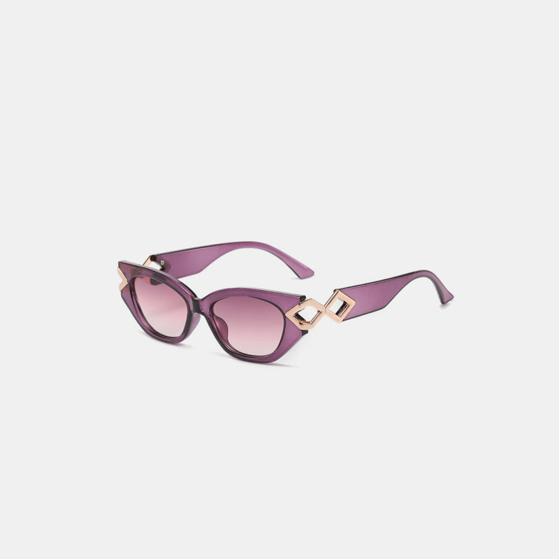 Purple polycarbonate cat-eye sunglasses feature upswept frames, pink gradient lenses, and sculptural geometric temple details with streamlined arms.