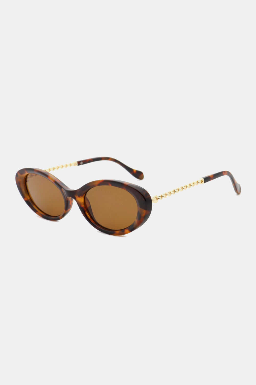 Tortoiseshell polycarbonate cat-eye sunglasses feature rounded brown lenses, a softly upswept silhouette, and contrasting gold-tone chain-detail metal-plastic temples.
