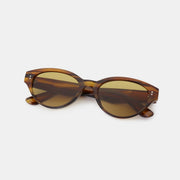 Brown tortoiseshell-style polycarbonate cat-eye sunglasses feature rounded, softly upswept frames, warm tinted lenses, and slender temples.