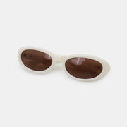 Cream polycarbonate cat-eye sunglasses feature softly sculpted oval brown lenses, a smooth rounded frame, gently raised outer edges, and a shaped bridge.