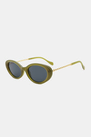Olive green polycarbonate cat-eye sunglasses feature rounded dark lenses, a softly upswept frame, and gold-toned metal-plastic hybrid temples.