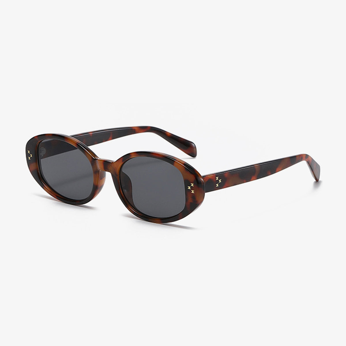 Brown tortoiseshell oval sunglasses feature softly rounded polycarbonate frames, dark lenses, slim temples, and star-like accents at the outer corners.