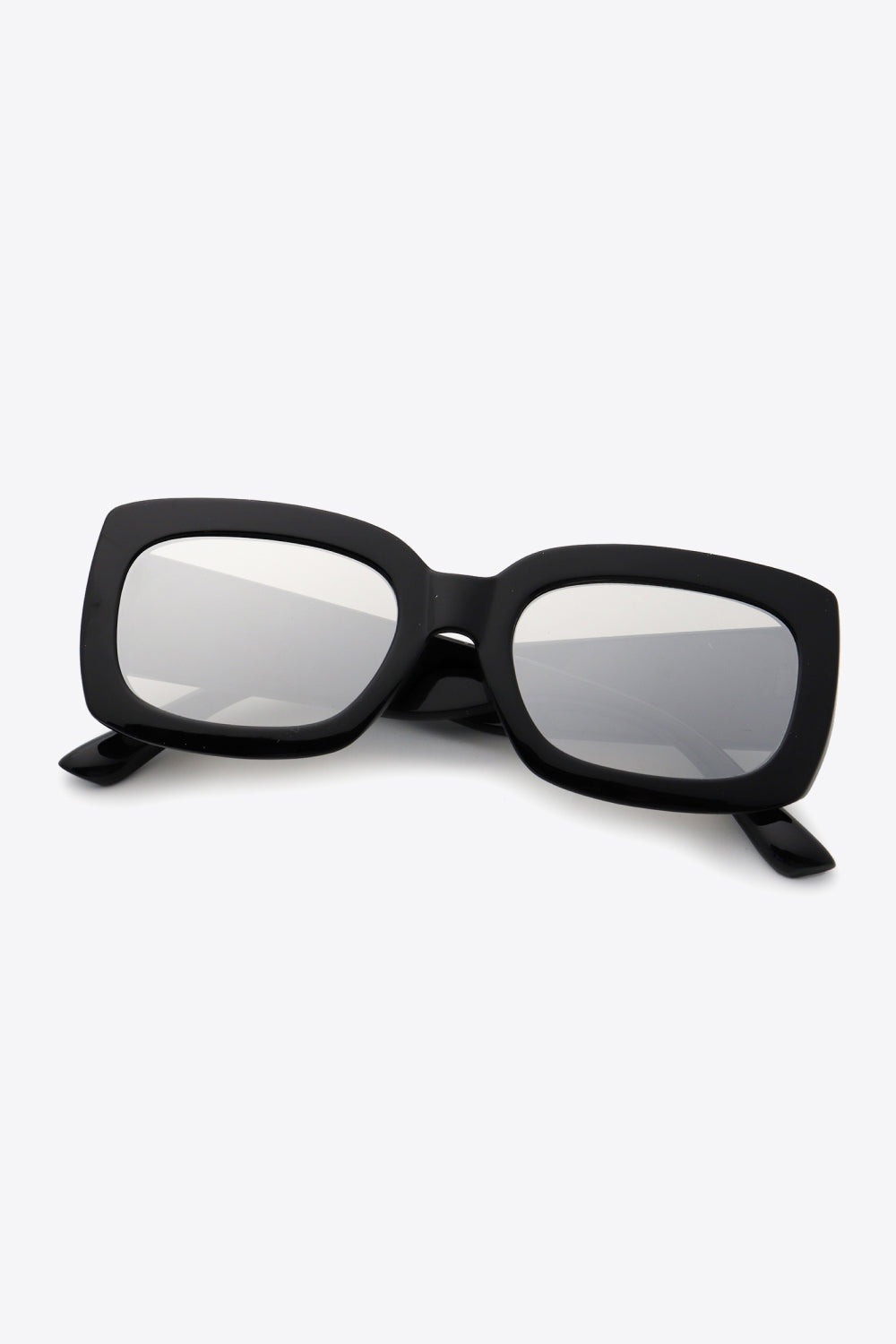 Black polycarbonate rectangle sunglasses feature a bold, substantial frame with softly rounded corners, broad temples, and reflective gray lenses.