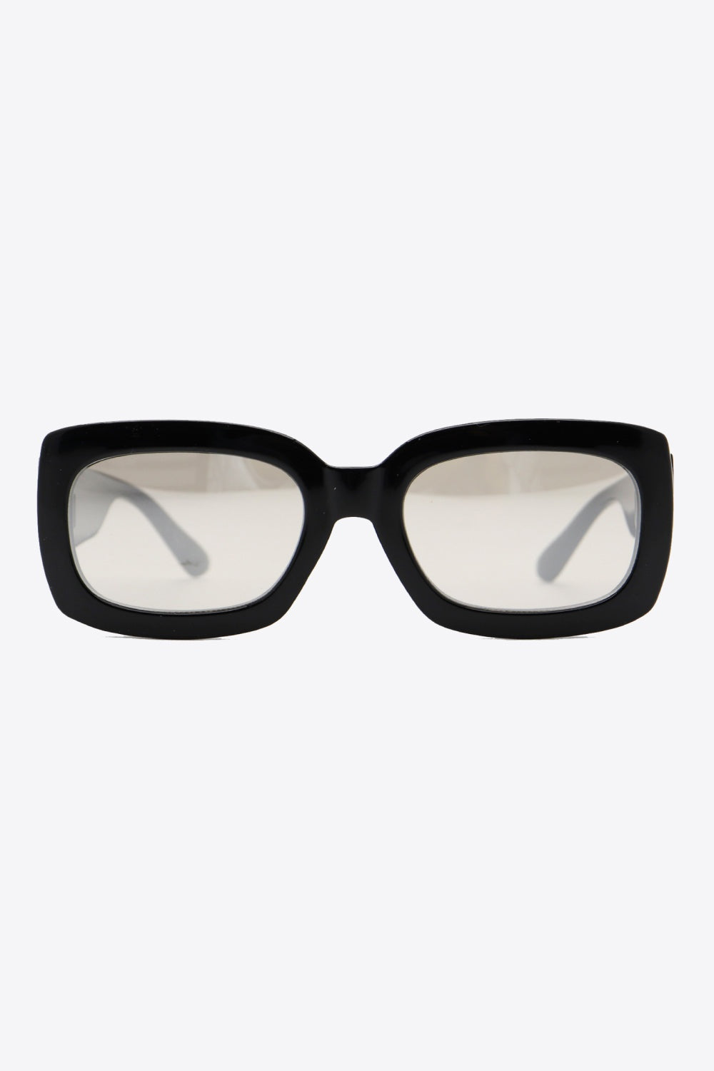 Bold black polycarbonate rectangle sunglasses feature a substantial front, softly rounded corners, wide lenses, and broad temples for a graphic oversized-inspired silhouette.