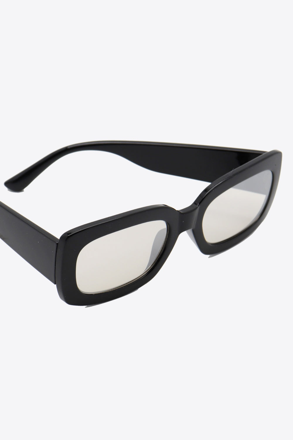 Bold black polycarbonate rectangle sunglasses feature softly rounded corners, a substantial frame, wide front, broad temples, and lightly tinted lenses.