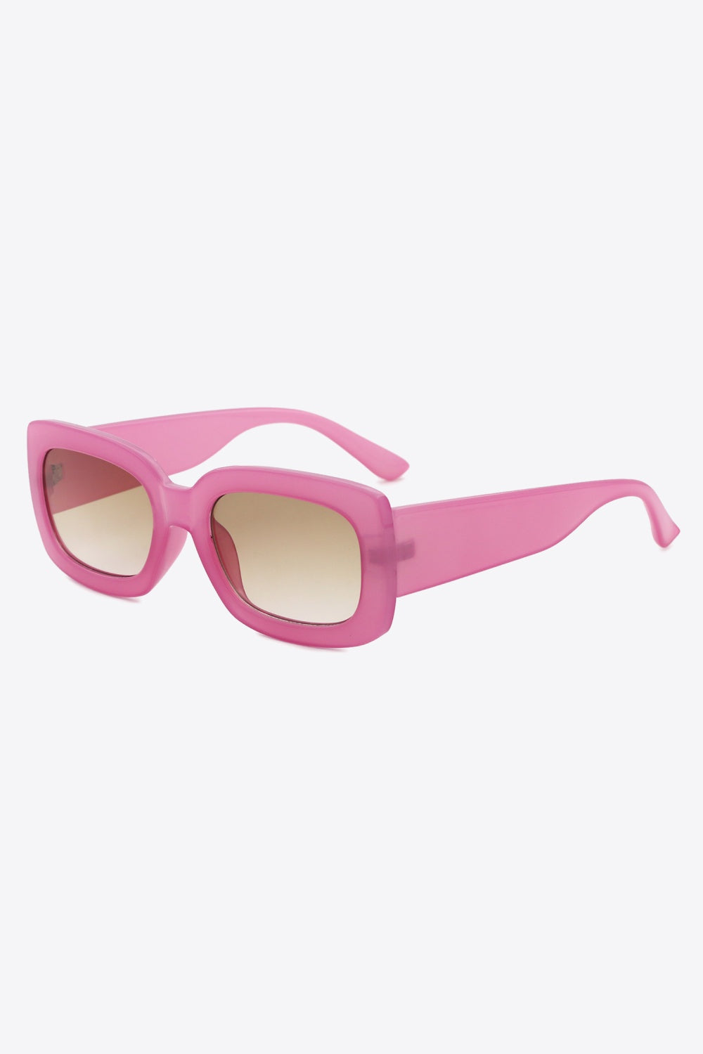 Bright pink polycarbonate rectangle sunglasses feature a bold, substantial frame with softly rounded corners, brown gradient lenses, and broad tapered temples.