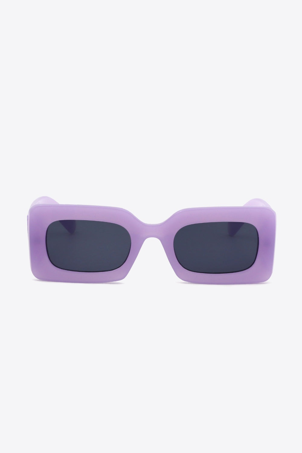 Front-facing purple polycarbonate rectangle sunglasses feature softly rounded dark lenses, a bold substantial frame, and sculptural temples for a modern silhouette.