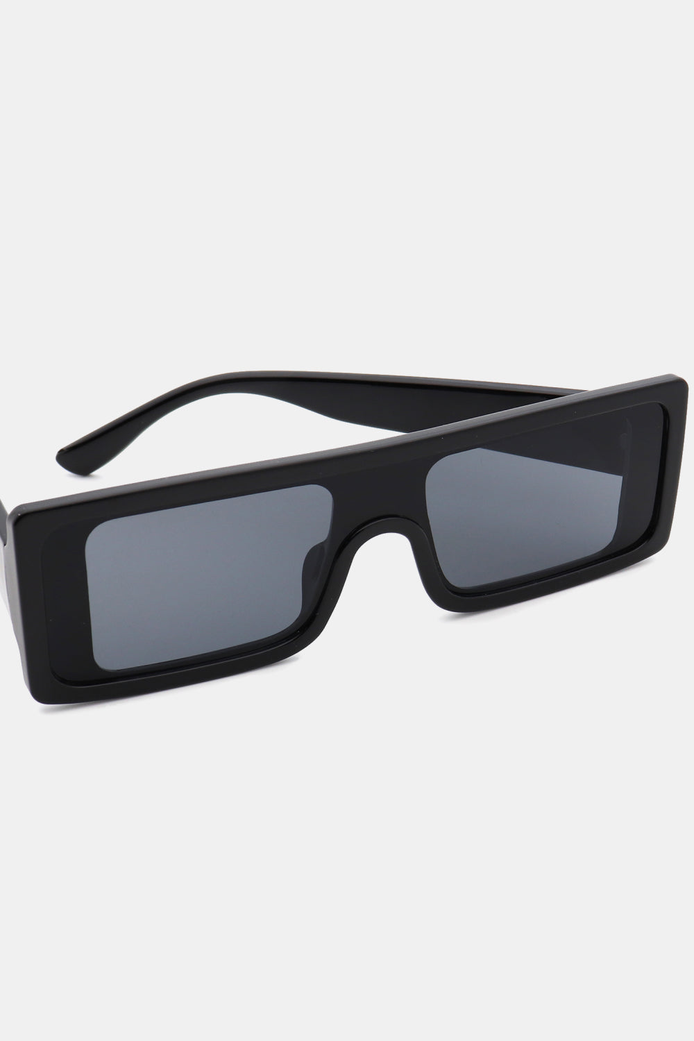 Black polycarbonate rectangle sunglasses feature a broad, structured frame, squared gray lenses, and streamlined temples for a bold modern silhouette.