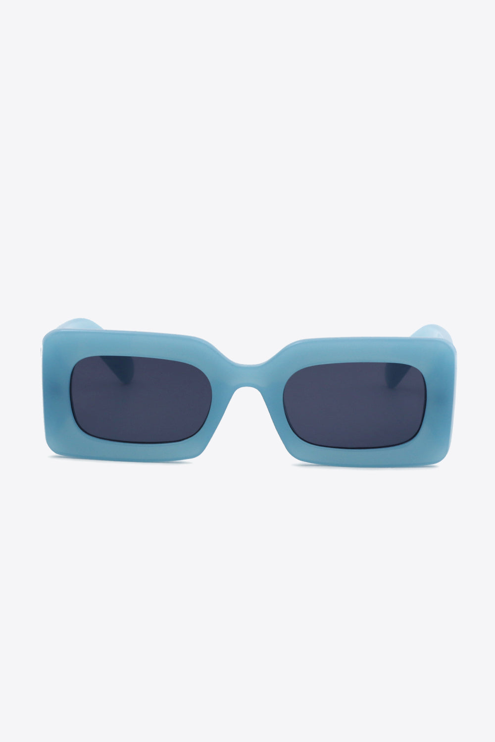 Turquoise polycarbonate frame rectangle sunglasses feature softly rounded dark lenses, a bold sculptural silhouette, and substantial temples.