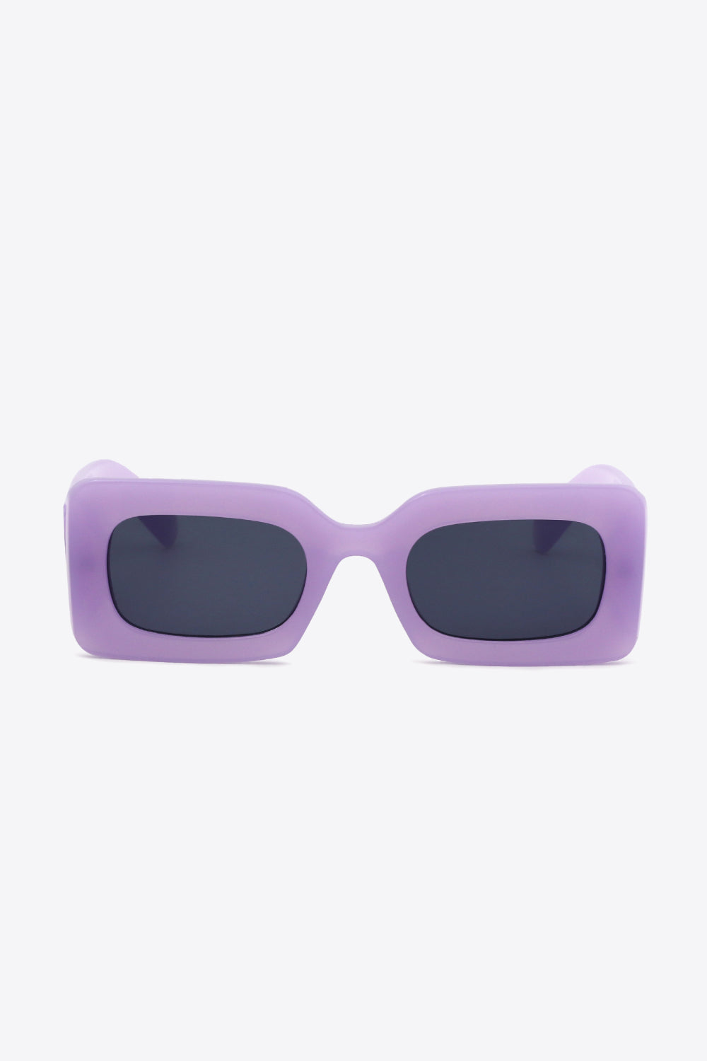 Front-facing purple polycarbonate rectangle sunglasses feature softly rounded dark lenses, a bold substantial frame, and sculptural temples for a modern silhouette.