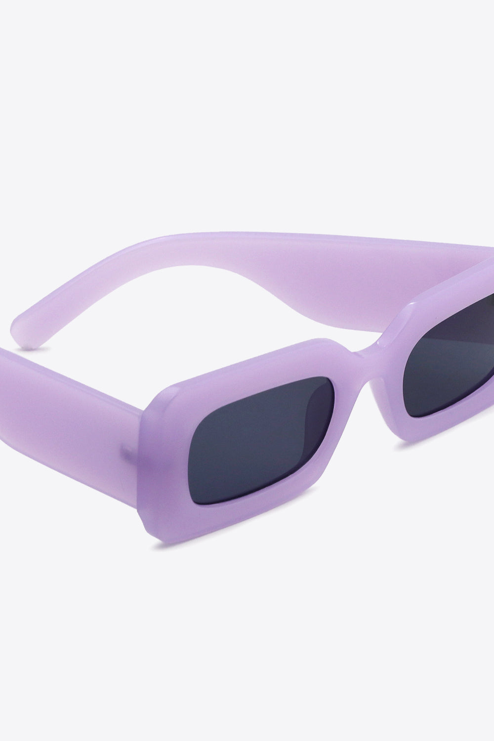 Lavender polycarbonate rectangle sunglasses feature softly rounded dark lenses and substantial sculptural temples for a bold, modern silhouette.