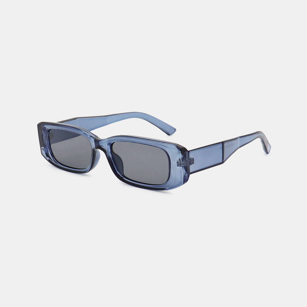 Translucent blue polycarbonate rectangle sunglasses feature broad squared frames, softly rounded corners, dark lenses, and wide temples for a modern structured silhouette.