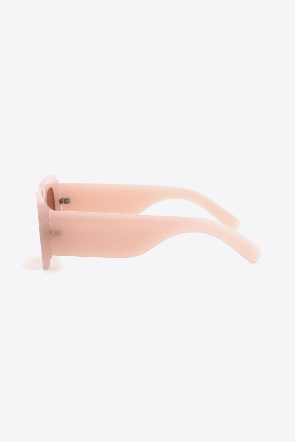 Soft pink polycarbonate rectangle sunglasses shown in side profile, featuring bold softly rounded frames and substantial sculptural temples.