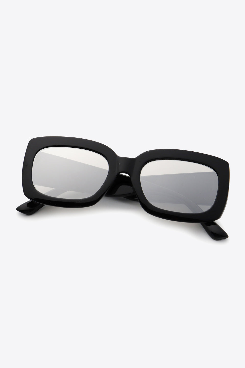 Black polycarbonate rectangle sunglasses feature a bold, substantial frame with softly rounded corners, broad temples, and reflective gray lenses.