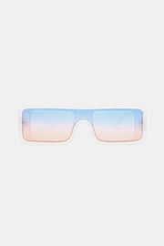 Translucent pale blue polycarbonate rectangle sunglasses feature a broad frame, squared lenses, and blue-to-pink gradient lenses for a modern statement silhouette.