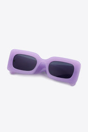 Lavender polycarbonate rectangle sunglasses feature a bold, softly rounded frame, dark lenses, and substantial sculptural temples for a modern silhouette.