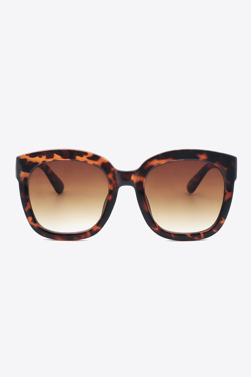 Bold tortoiseshell polycarbonate frame sunglasses feature a softly rounded square silhouette, substantial temples, and brown gradient acetate lenses.