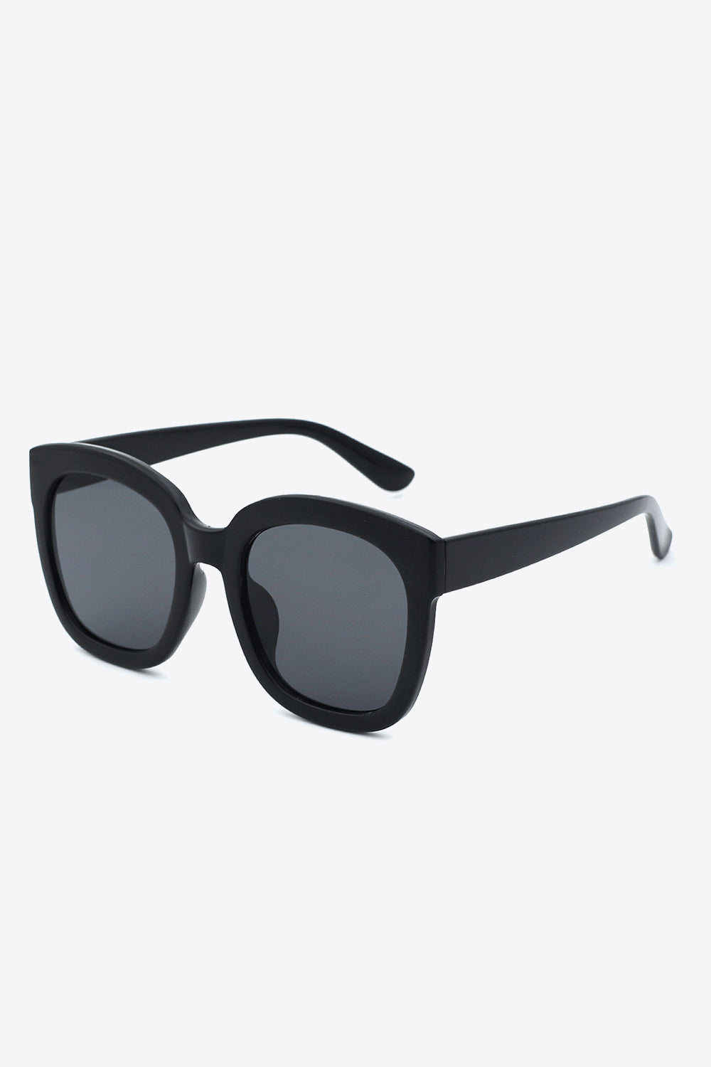 Black polycarbonate frame square sunglasses with softly rounded edges, dark acetate lenses, substantial matching temples, and a bold polished silhouette.