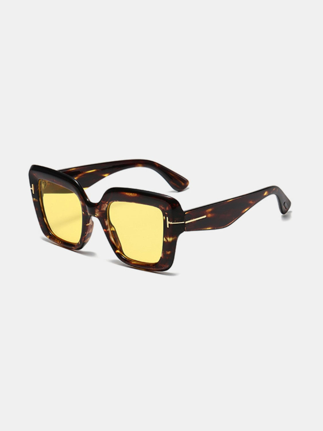 Square polycarbonate sunglasses feature a tortoiseshell frame with softly rounded edges, yellow lenses, broad temples, and subtle metal-look hinge accents.