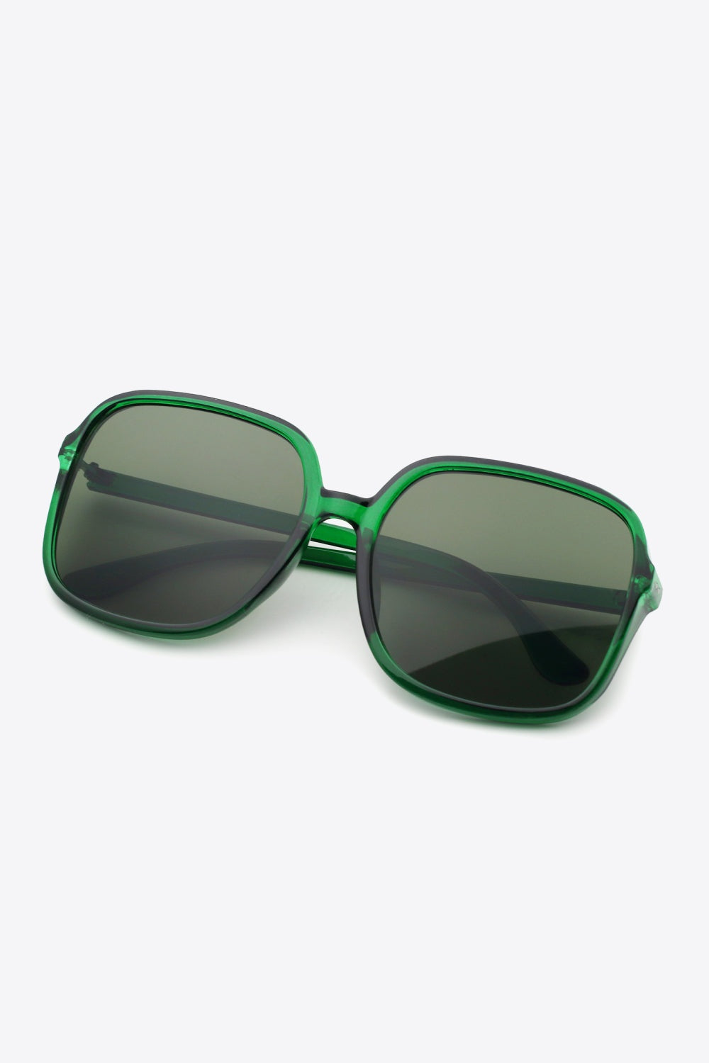 Green polycarbonate square sunglasses with softly rounded corners, broad dark lenses, a defined top line, and sleek temples create a bold, streamlined silhouette.
