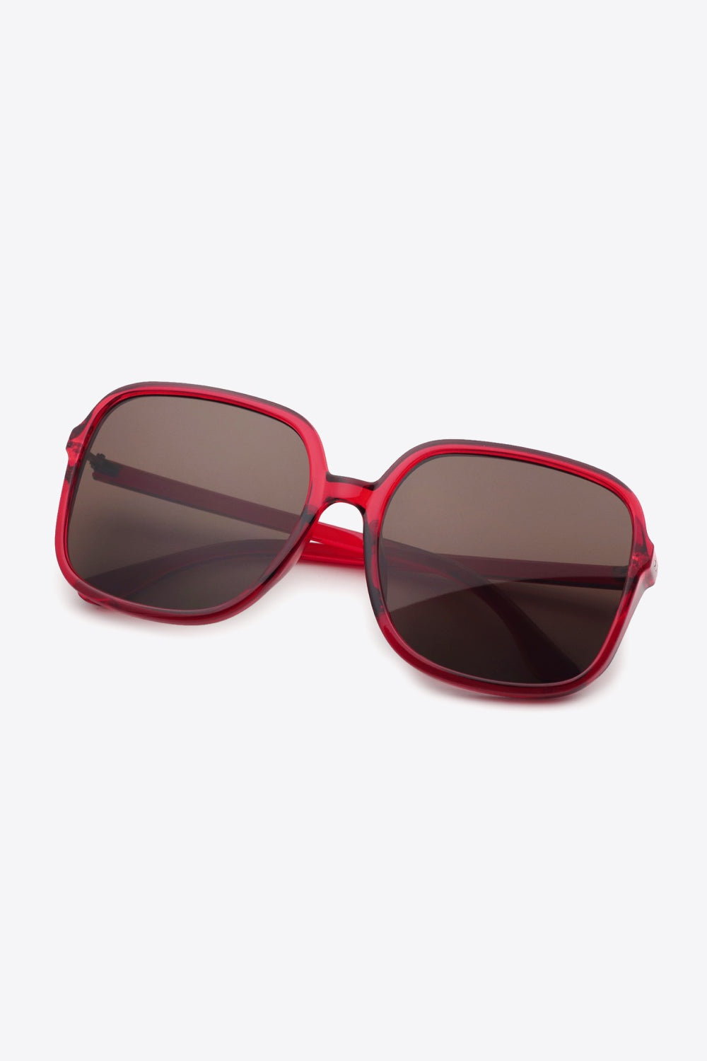 Red polycarbonate square sunglasses with softly rounded frames, broad brown lenses, a defined top line, and sleek temples create a bold, polished silhouette.