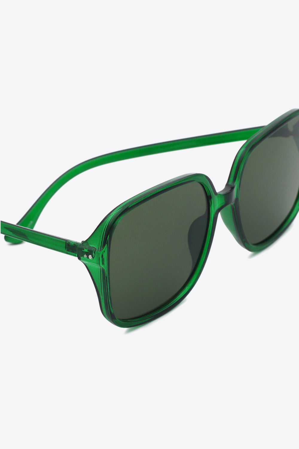 Translucent green polycarbonate square sunglasses feature broad dark lenses, softly rounded frames, a defined top line, and sleek substantial temples.