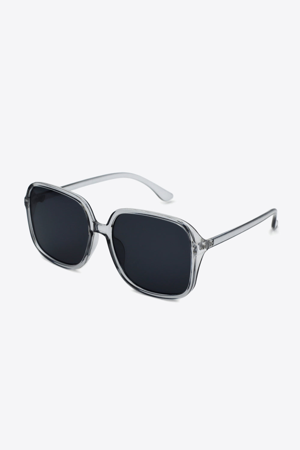 Square sunglasses with a translucent gray polycarbonate frame, broad dark lenses, softly rounded corners, a defined top line, and sleek streamlined temples.