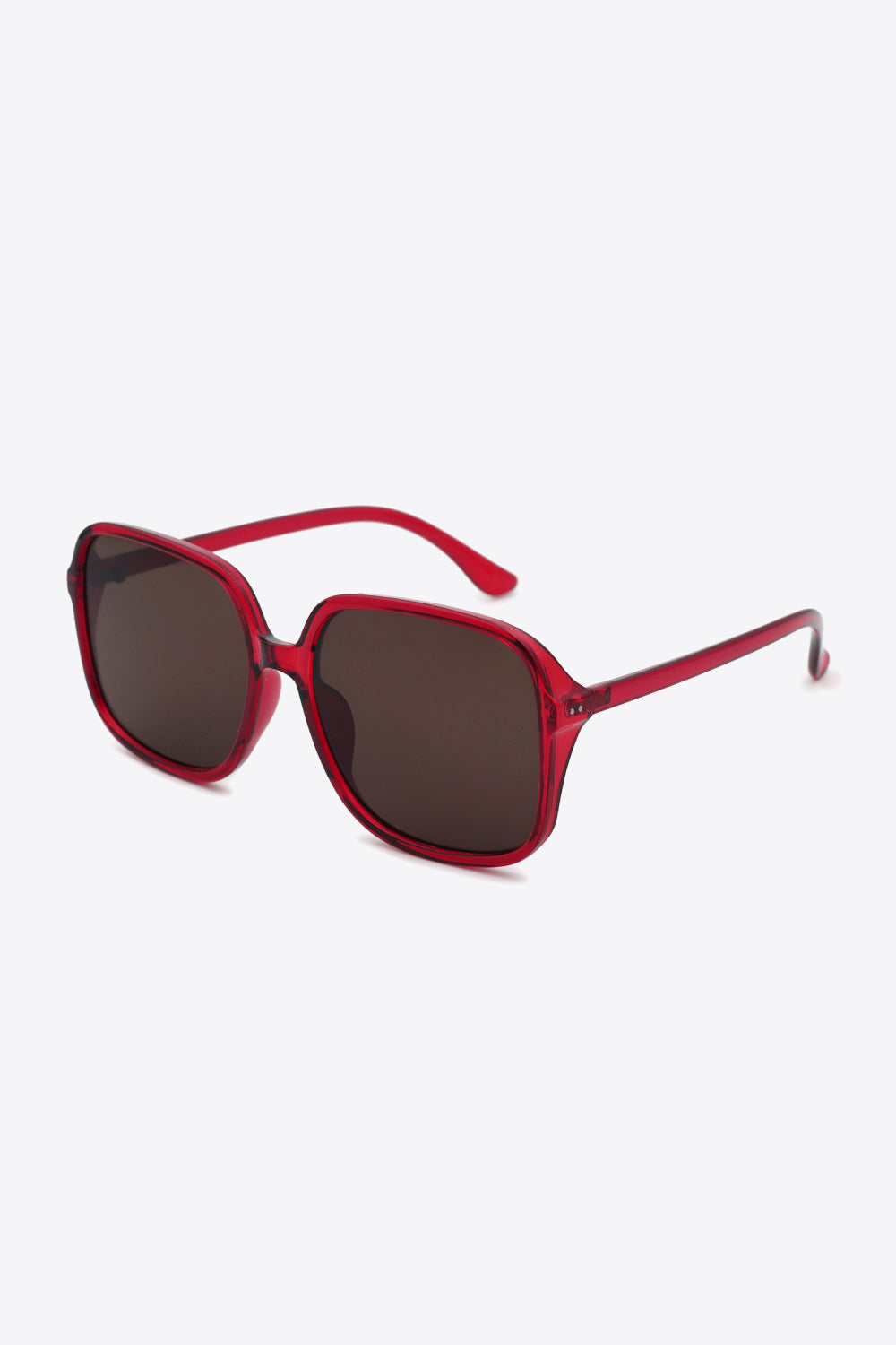 Translucent red polycarbonate square sunglasses feature softly rounded frames, broad dark lenses, a defined top line, and sleek matching temples.