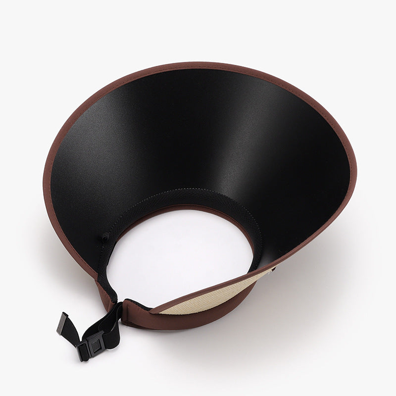 Black adjustable sun hat with a curved visor, generous 4.5-inch brim, brown trim, open-back crown, and rear buckle fastening.