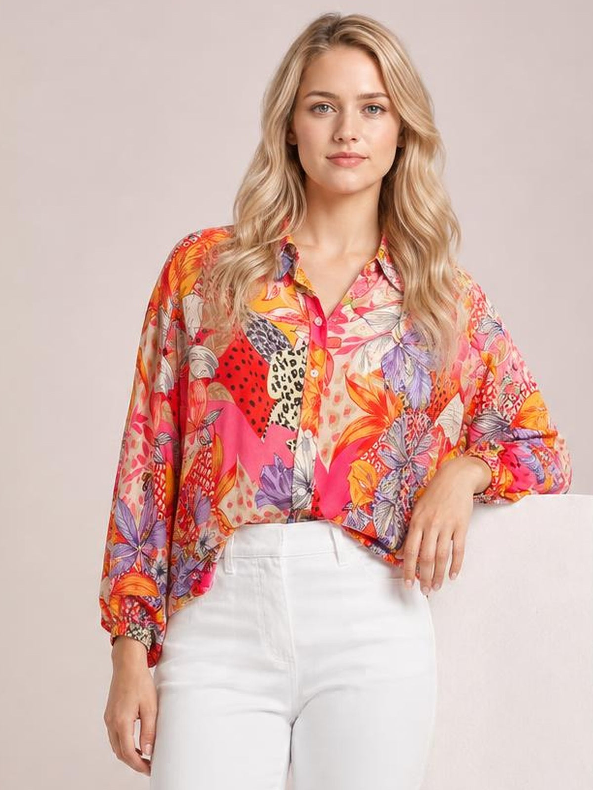 Model wears a vibrant multicolor printed button-down shirt with long sleeves, a collared neckline, front buttons, and a relaxed silhouette.