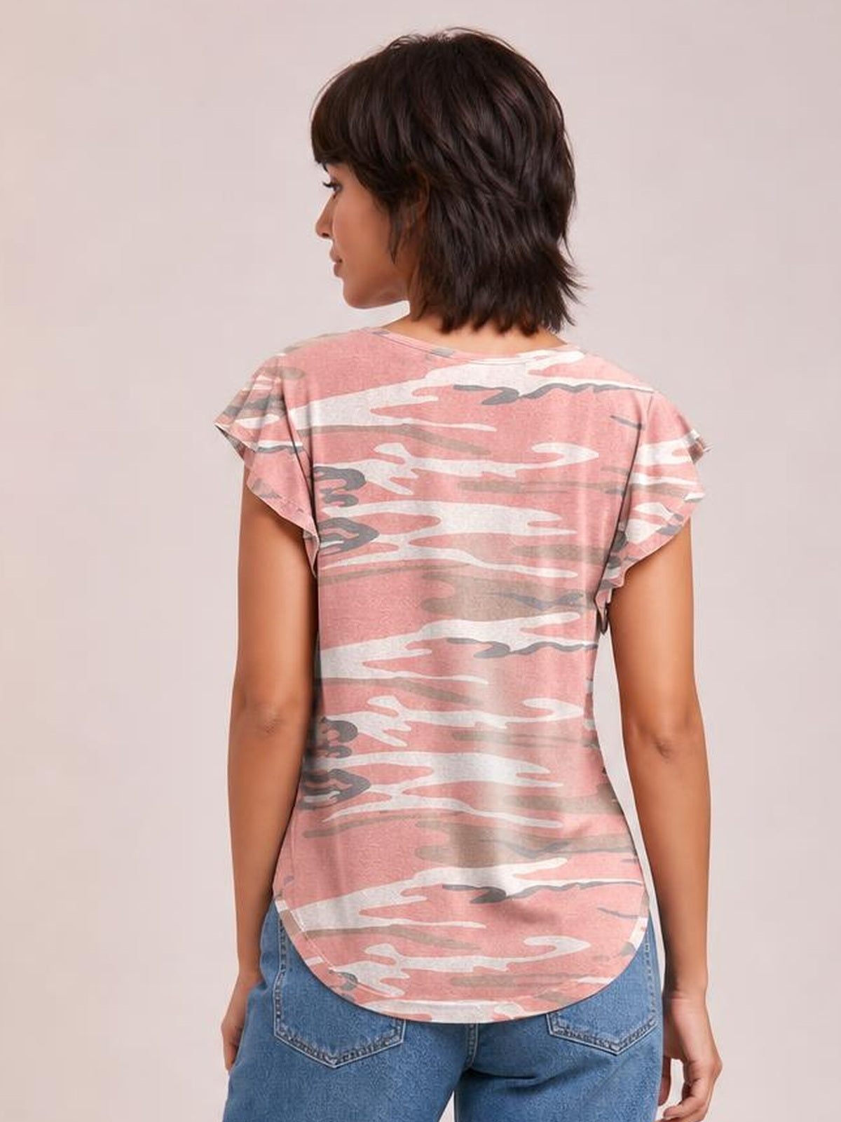 A model wears a pink camouflage-print round-neck short-sleeve T-shirt with a fitted silhouette and curved hem, shown from the back.