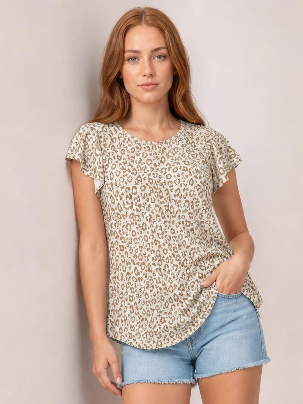 Model poses in a beige leopard-print round-neck short-sleeve T-shirt with a relaxed, slightly stretchy silhouette and curved hem.