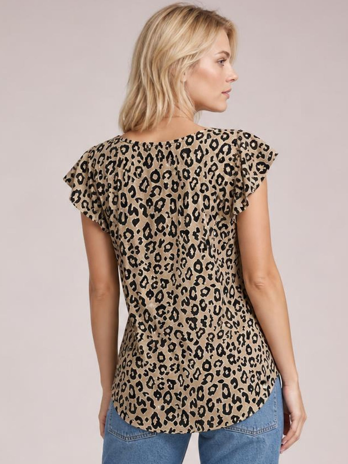 Model shown from behind wearing a tan leopard-print round-neck short-sleeve T-shirt with flutter sleeves and a relaxed, curved-hem silhouette.