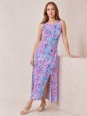 Model in a multicolor pink, blue, and lavender printed midi dress with a round neck, sleeveless cut, A-line silhouette, and front slit.