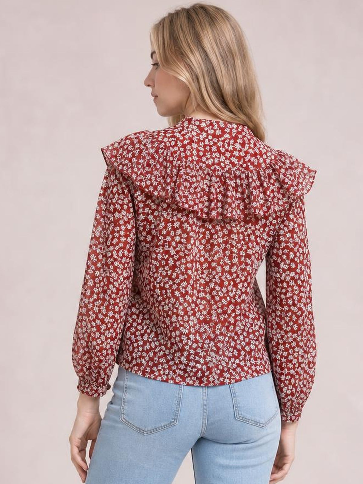 Model shown from behind wears a red floral-print blouse with a statement collar, long sleeves, and a fitted waist-length silhouette.