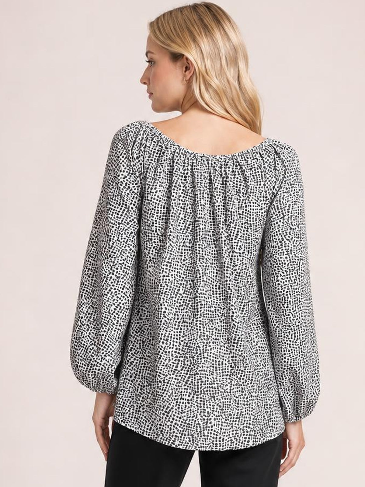 Model shown from behind wears a black-and-white printed blouse with long balloon sleeves, a relaxed long silhouette, and a softly gathered neckline.