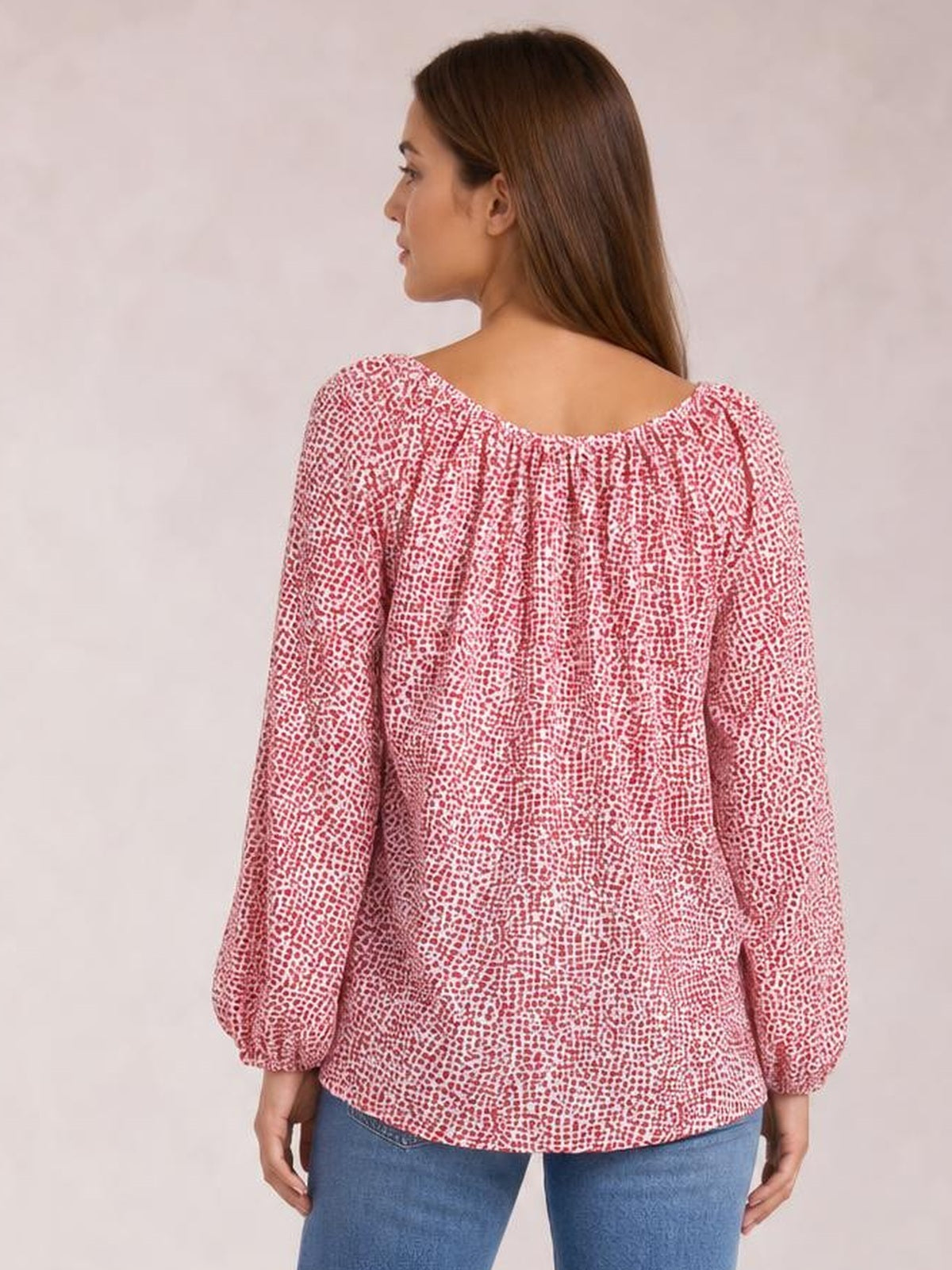 Model shown from behind wears a pink printed blouse with a gathered neckline, long balloon sleeves, and a loose, flowing silhouette.