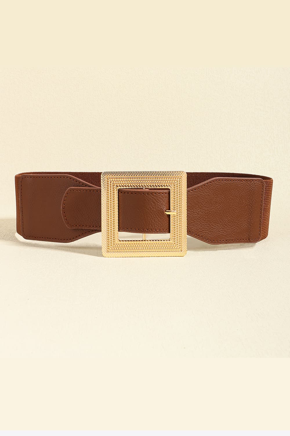 Broad brown PU leather belt with softly contoured, stitched panels and a standout square textured alloy buckle.