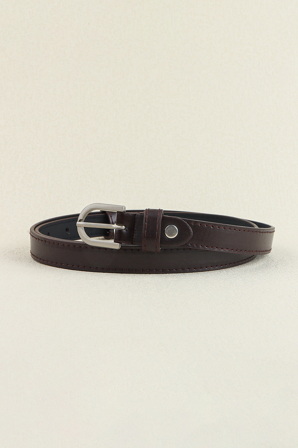 Slim dark brown PU leather belt with stitched edges, a classic silver-tone pin buckle, adjustment holes, and a keeper loop for a polished finish.
