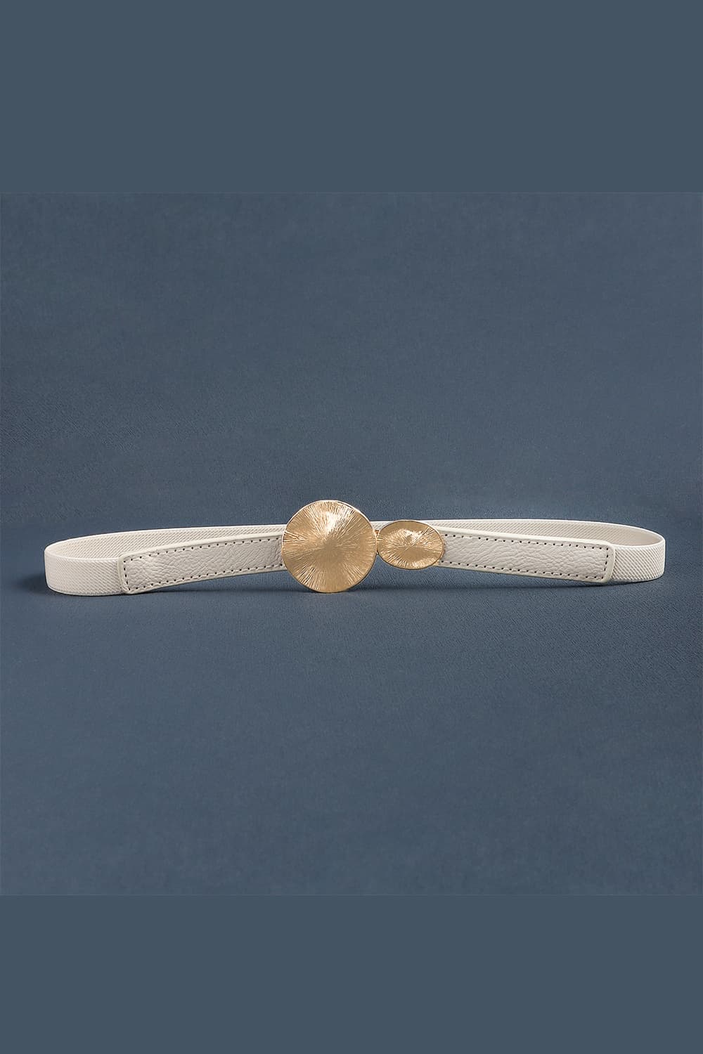 Slim white PU leather belt with stitched construction and a sculptural gold alloy buckle featuring two rounded, softly textured discs.