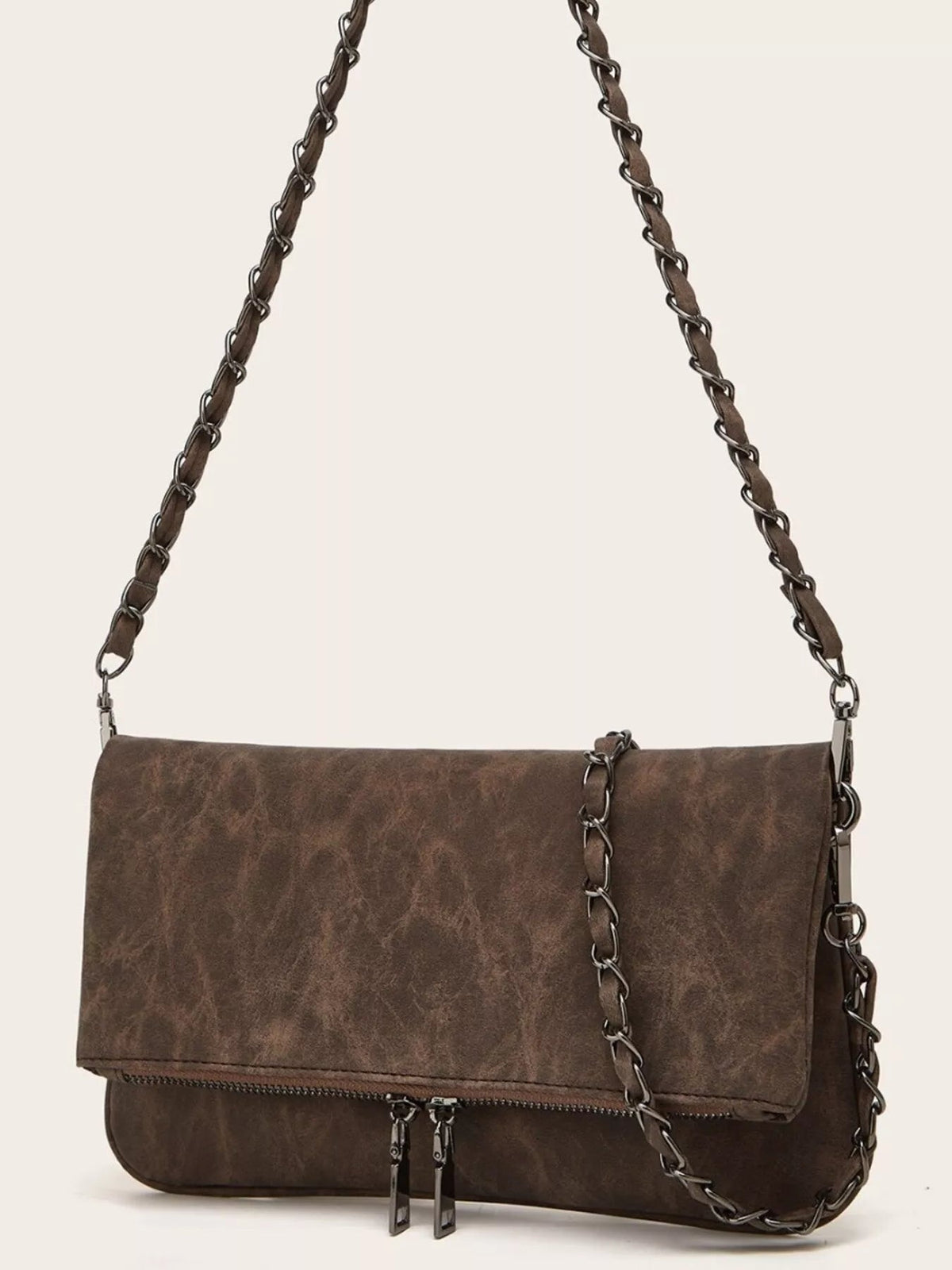 Medium brown PU leather shoulder bag with a flap closure, front zipper pocket, and intertwined chain strap with leather detailing.