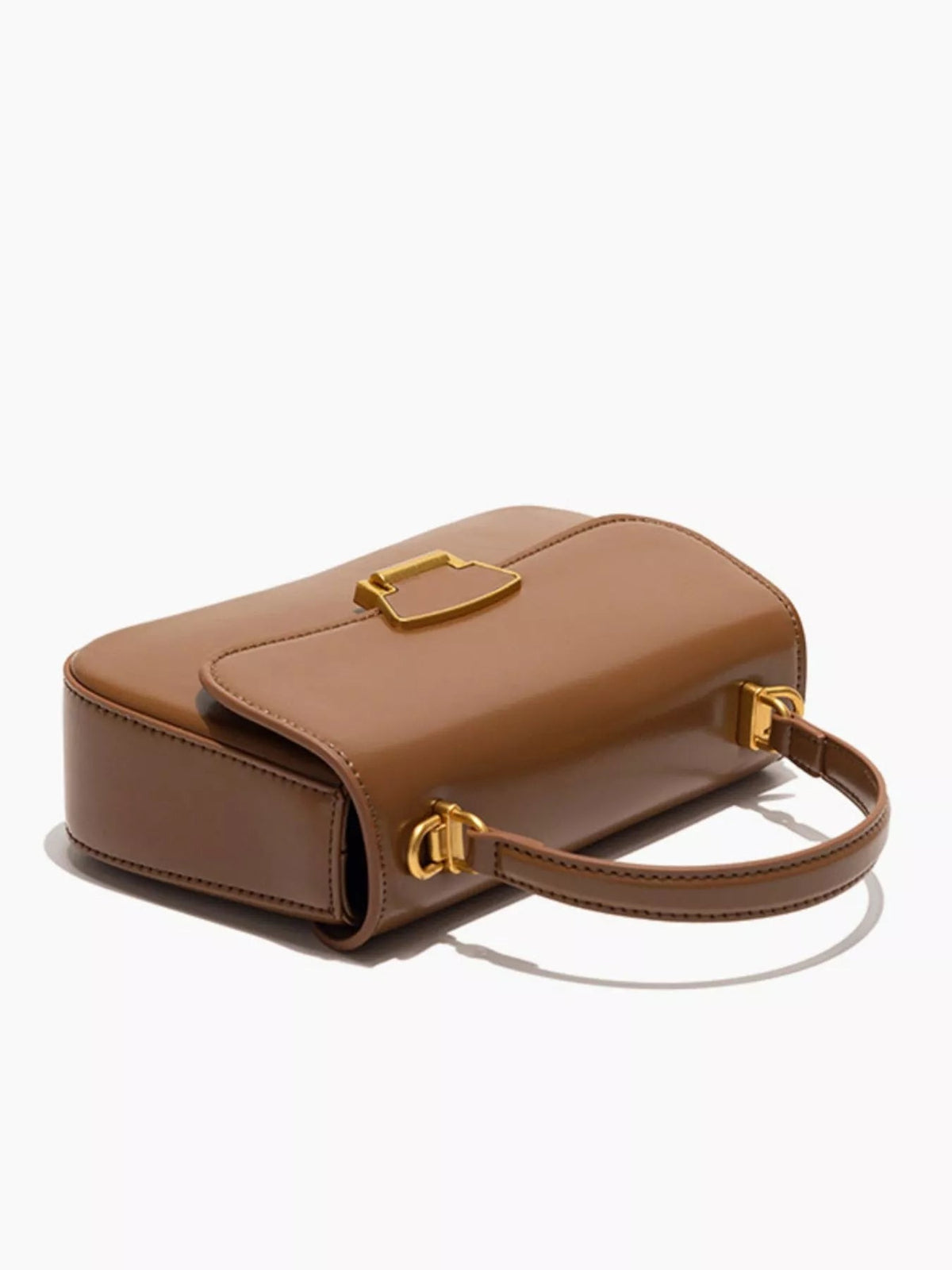 Small brown PU leather crossbody bag with a structured rectangular silhouette, rounded edges, stitched detailing, flap closure, and gold-tone hardware.