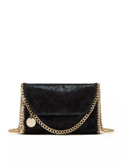Small black PU leather crossbody bag with a flap front, braided edge construction, and gold-tone chain trim draped across the front.