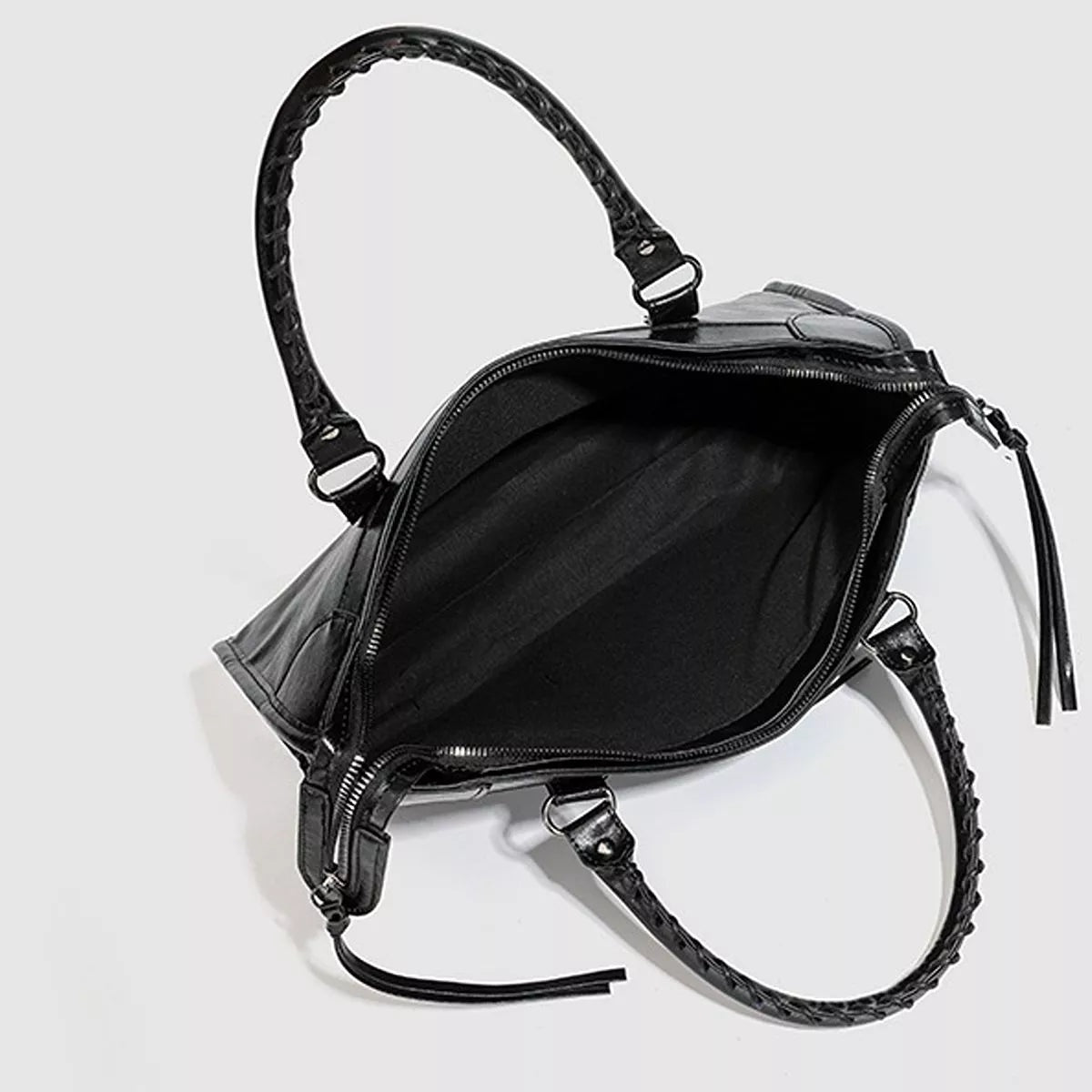 Black medium PU leather handbag with a braided top handle, open zippered compartment, structured silhouette, and detachable shoulder strap.