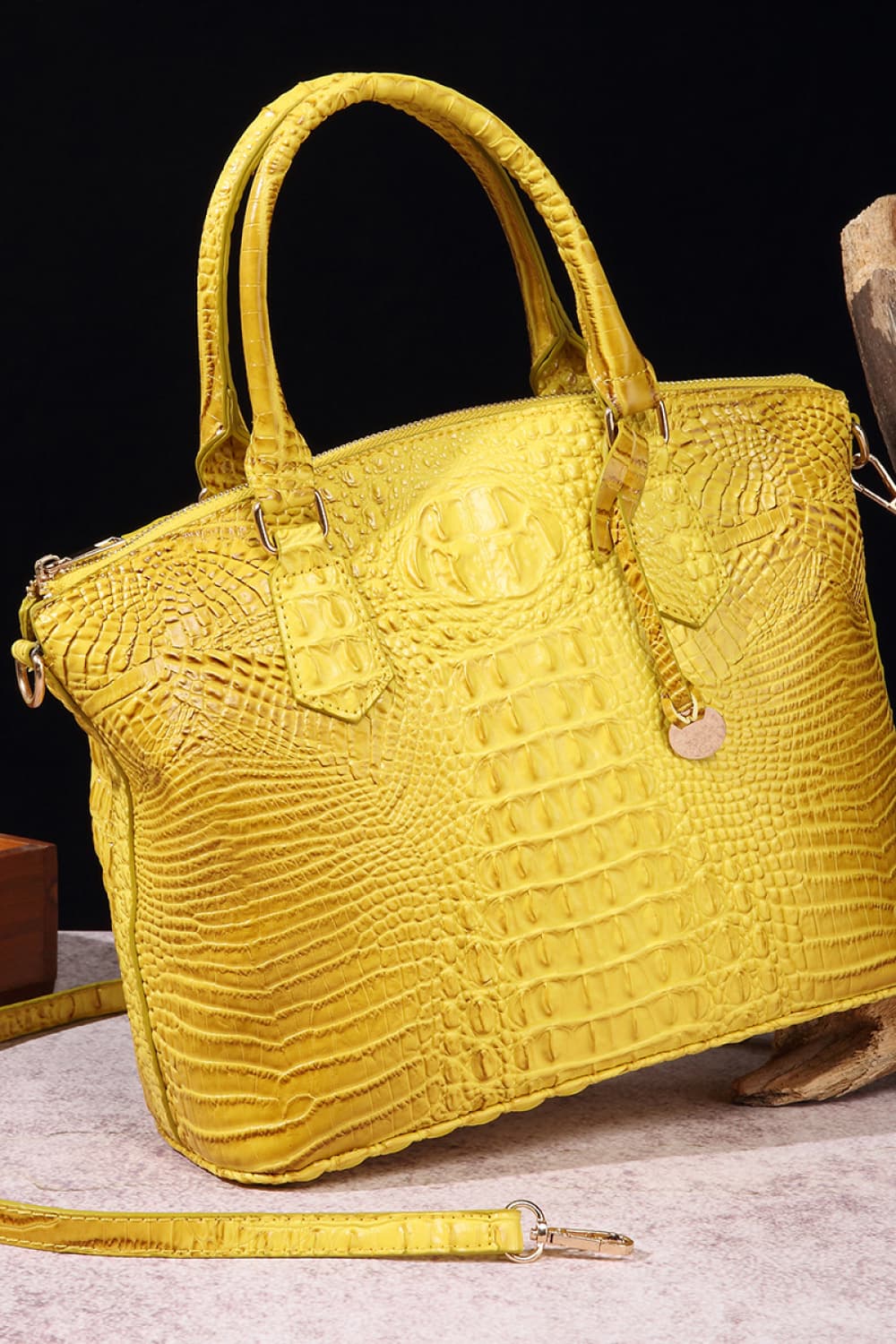Bright yellow PU leather handbag with a structured, softly shaped silhouette, raised crocodile-embossed texture, rounded top handles, zip-top closure, and shoulder strap.
