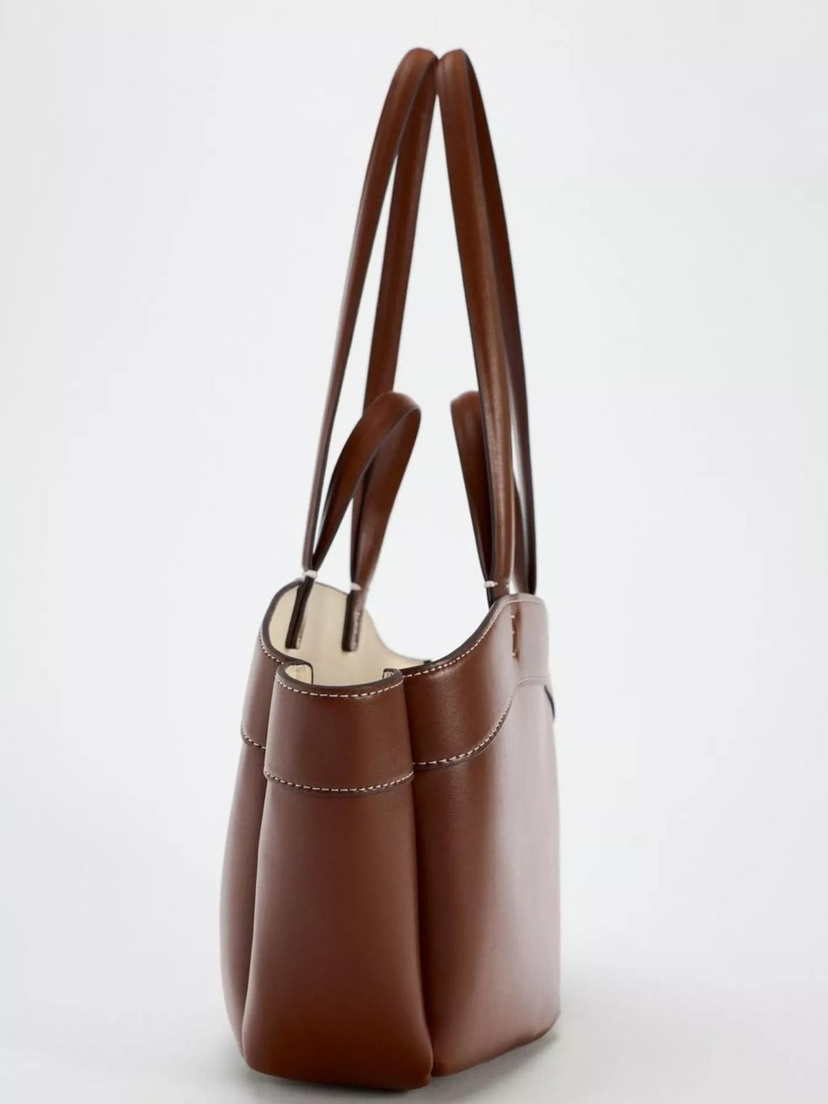 Large brown PU leather tote bag with a structured silhouette, open top, twin long shoulder straps, roomy side panels, and contrast stitching.