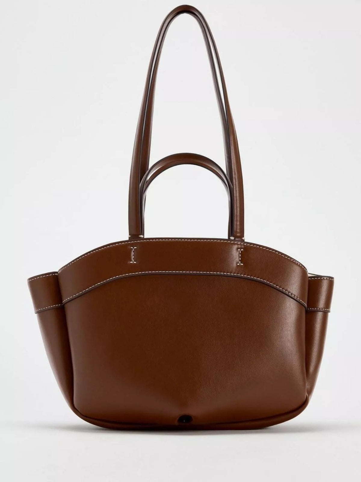 Large brown PU leather tote bag with a structured silhouette, double top handles, curved upper panel, side gussets, and contrasting topstitching.